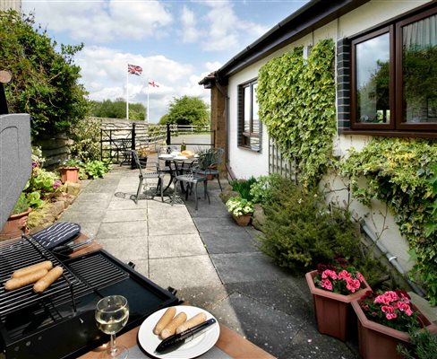 Large private patio garden with gas barbecue and seating